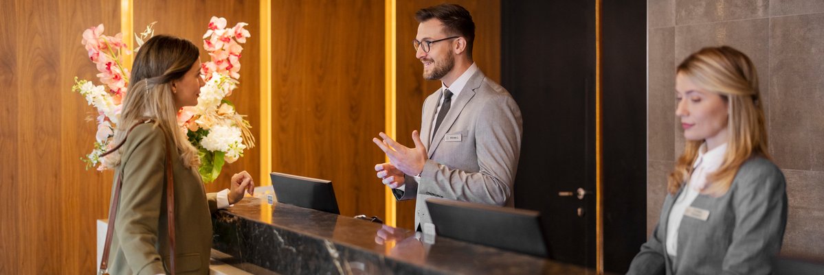 Woman checking in to hotel.