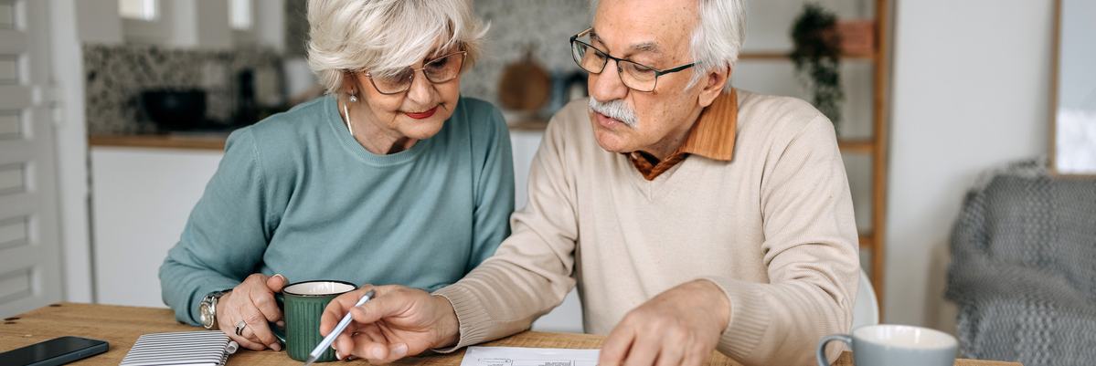 Mature couple looking at documents together.