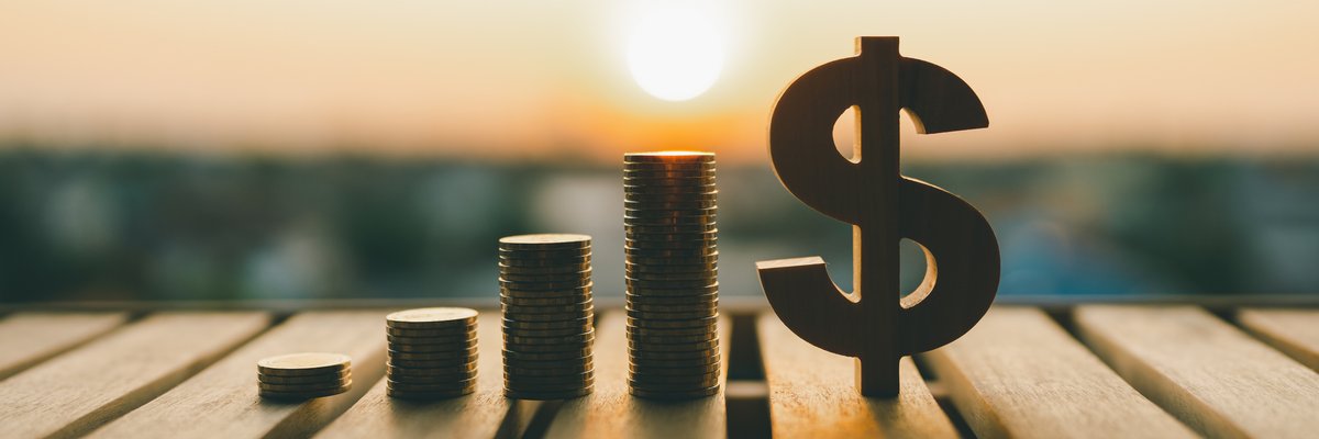 Stacks of coins in increasing height following by a large dollar sign.