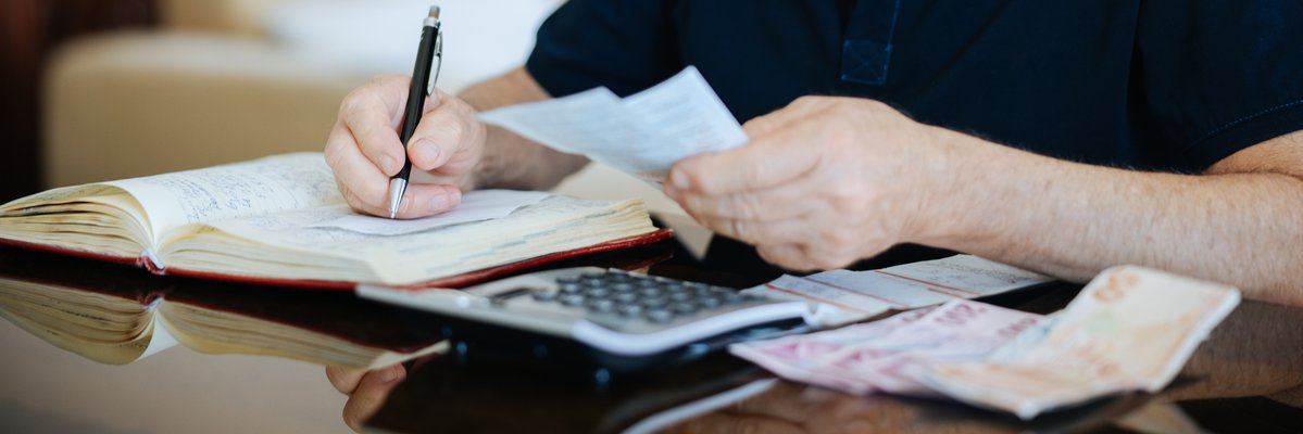 Person making calculations in notebook