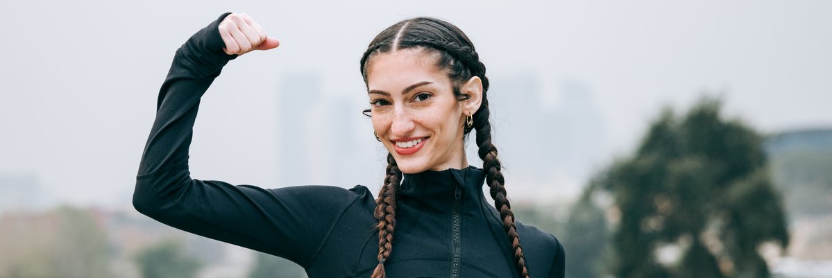 Happy woman flexing bicep.