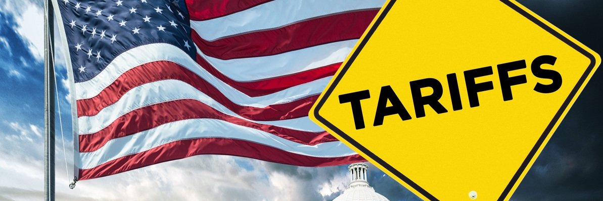 Tariffs sign next to American flag and Capitol building.