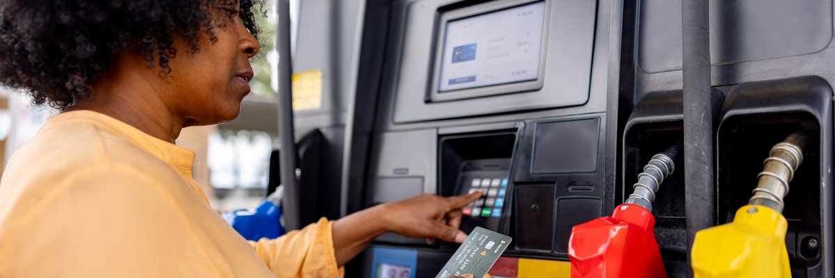Person uses credit card to pay at gas pump.