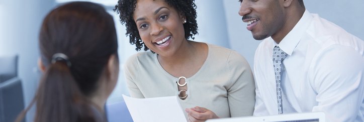 A couple discusses their finances with a bank associate.
