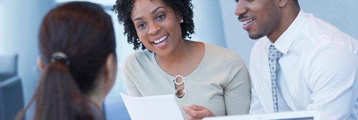 A couple discusses their finances with a bank associate.