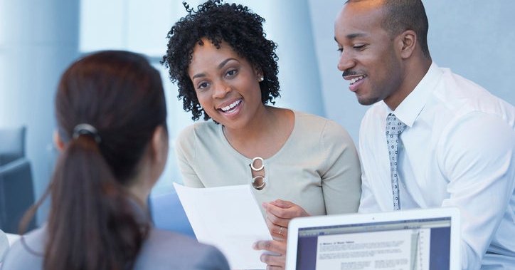A couple discusses their finances with a bank associate.