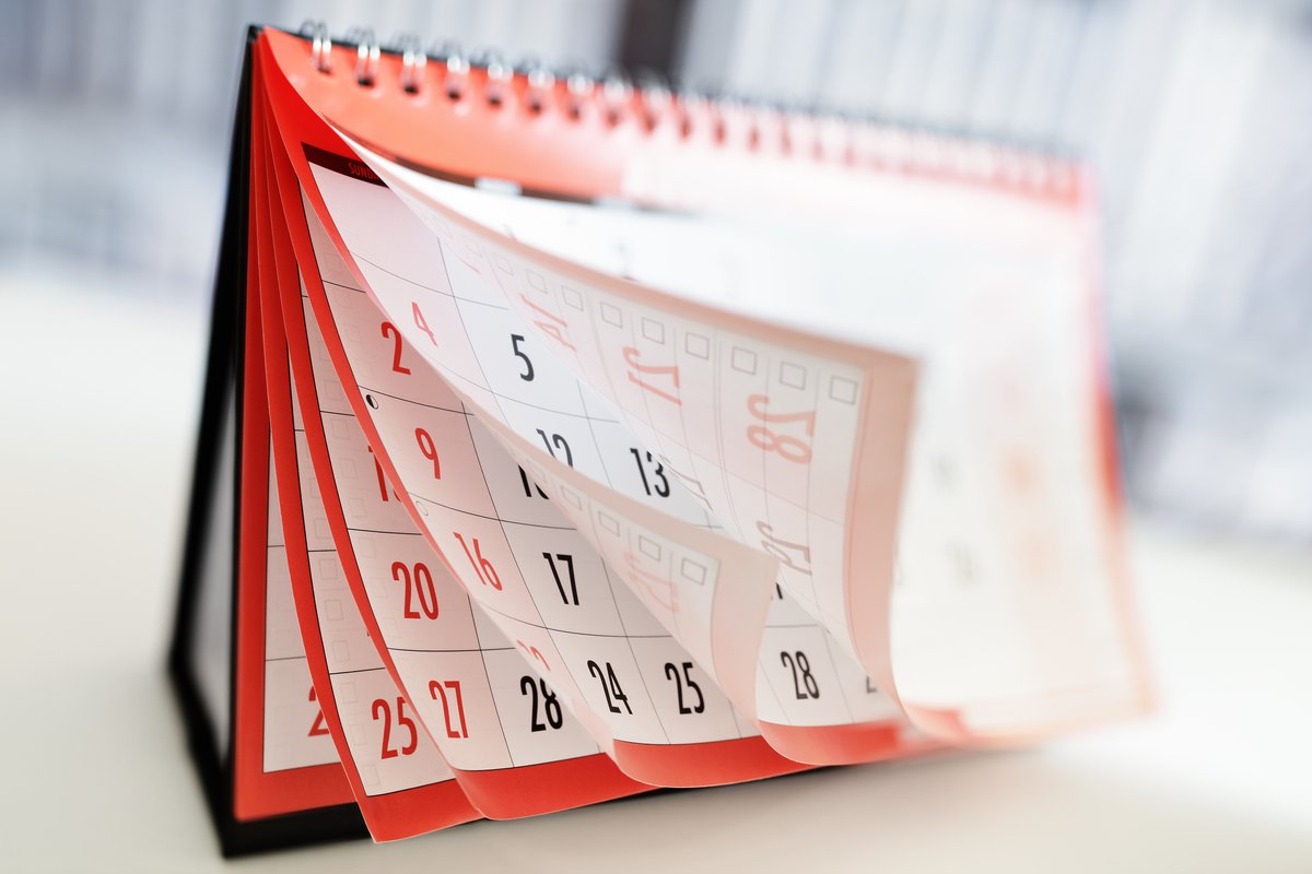 desktop calendar with pages flipping past