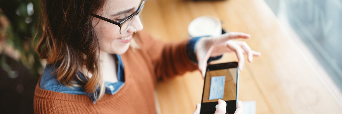 Woman depositing check using her cellphone.