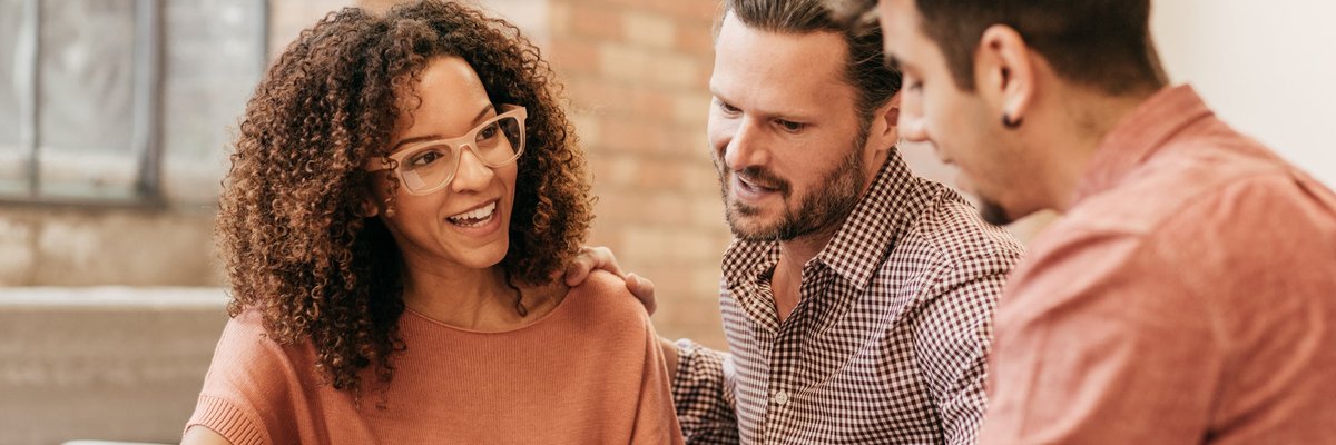 A couple meets with a financial advisor in their office.
