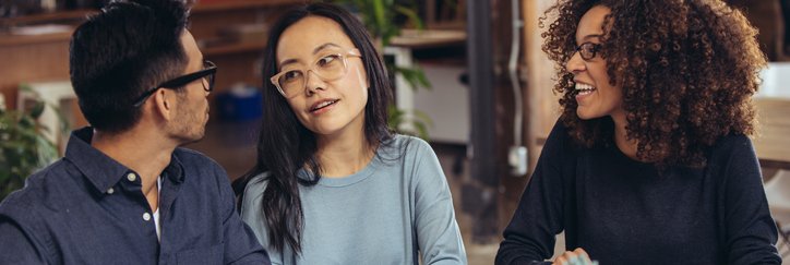A couple receives financial advice from an associate.