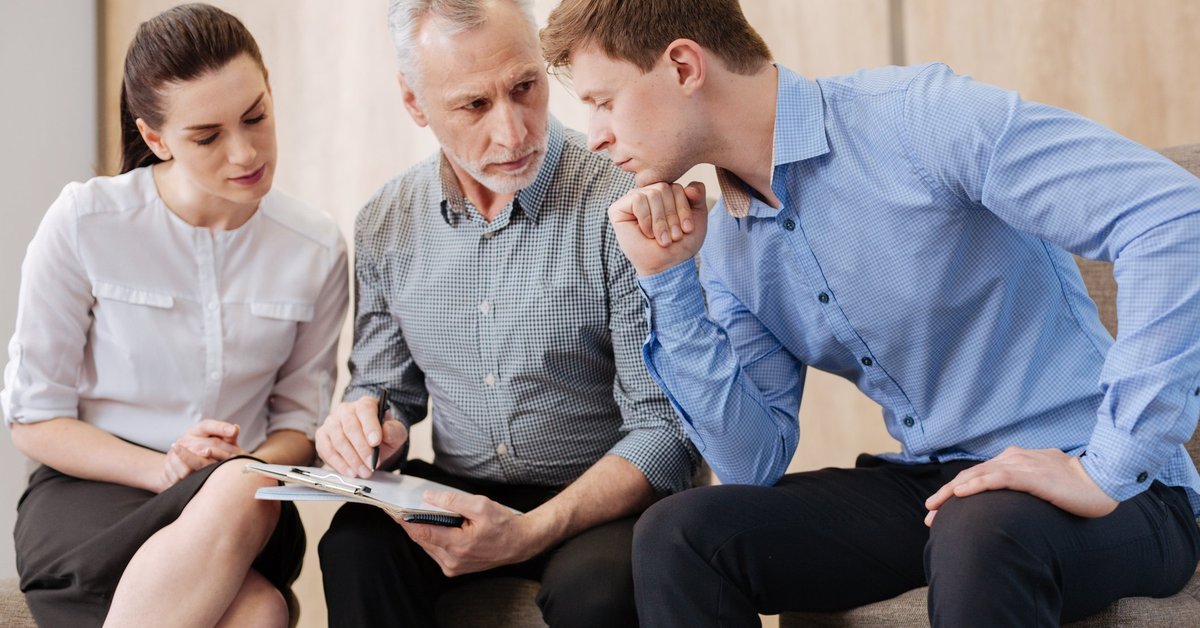 Baby boomer having a fraught discussion with two millennials.