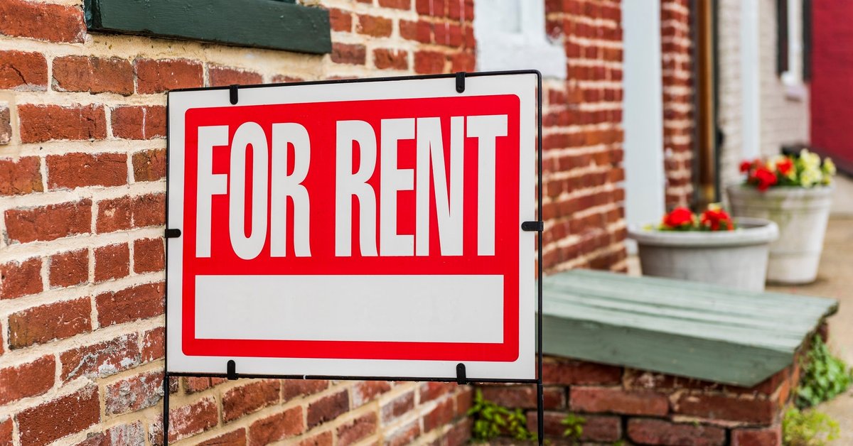 "for rent" sign outside of brick building
