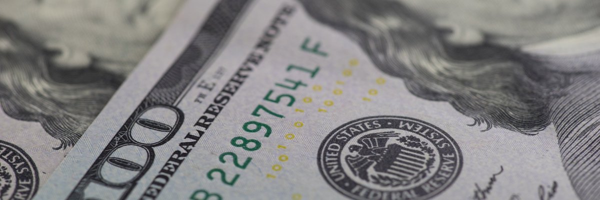 Close up image of two one hundred dollar bills.