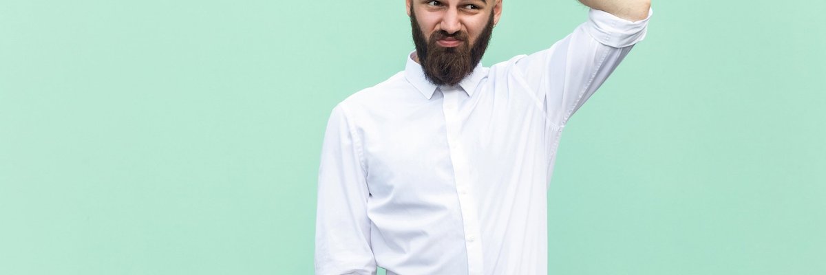 Confused man scratching his head