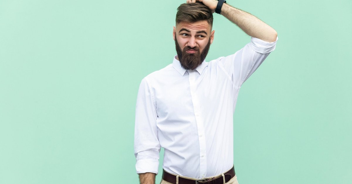 Confused man scratching his head