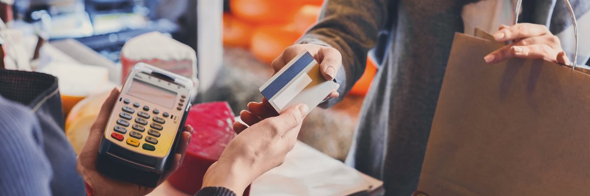 Person paying for items at a store with a credit card.