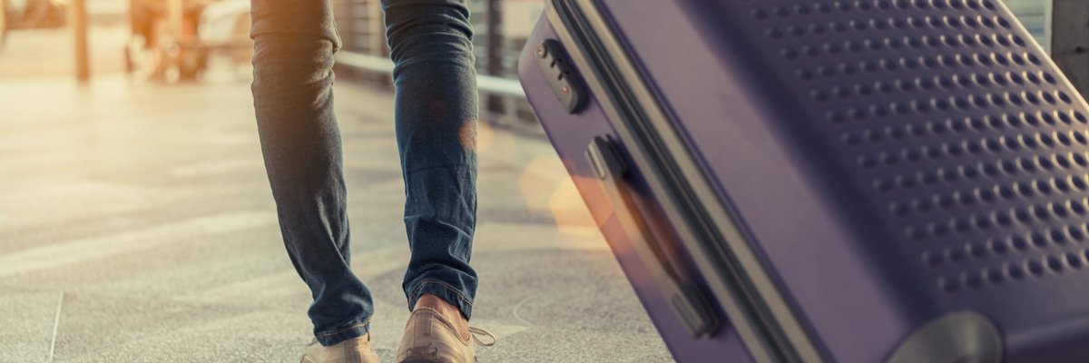 Rolling a roller bag through an airport