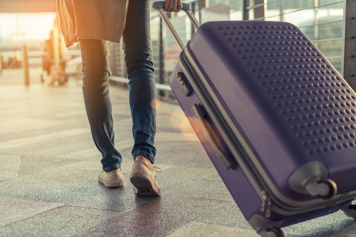 Rolling a roller bag through an airport