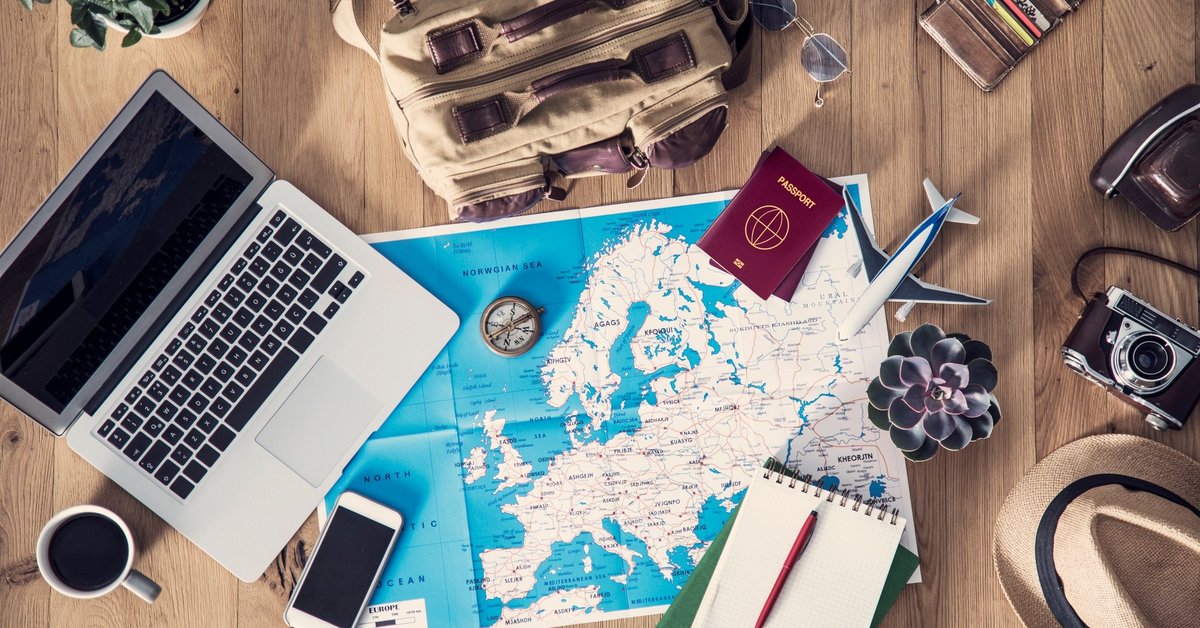 Map of Europe with laptop, phone, passport, and notebook