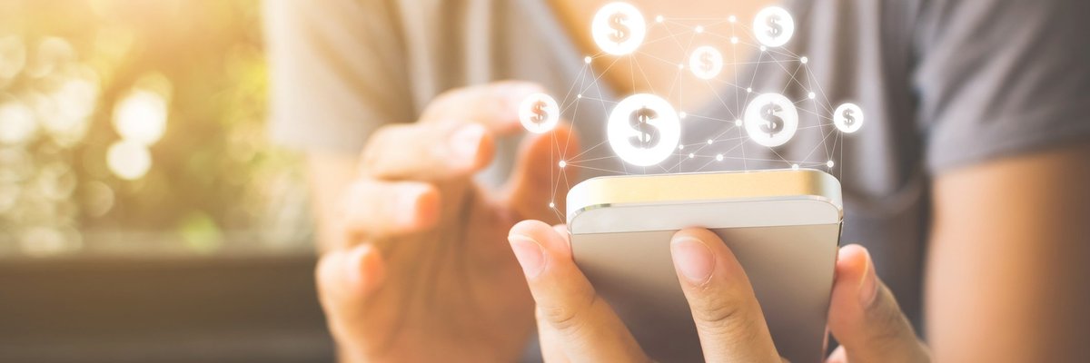 Person holding their smartphone with a graphic of a web of dollar signs coming from the top of the phone.
