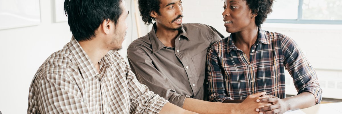 A couple meets with a banker to discuss their finances.