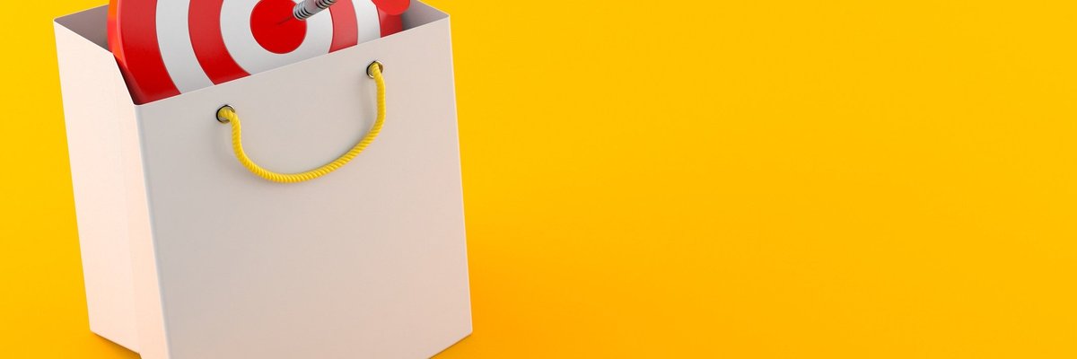 A target in a shopping bag with a dart in the bullseye