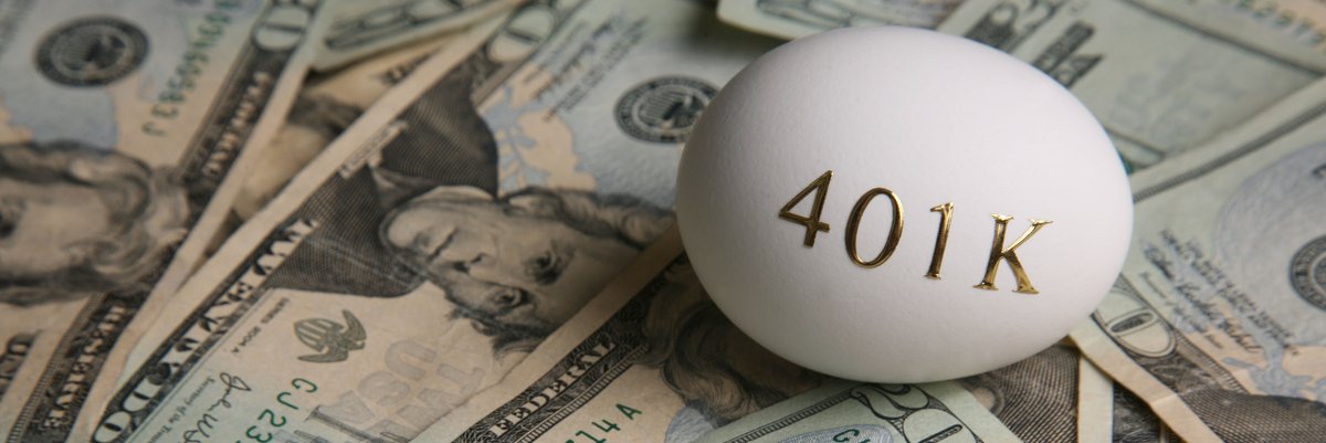 Egg with 401k in gold print on top of a messy pile of money.