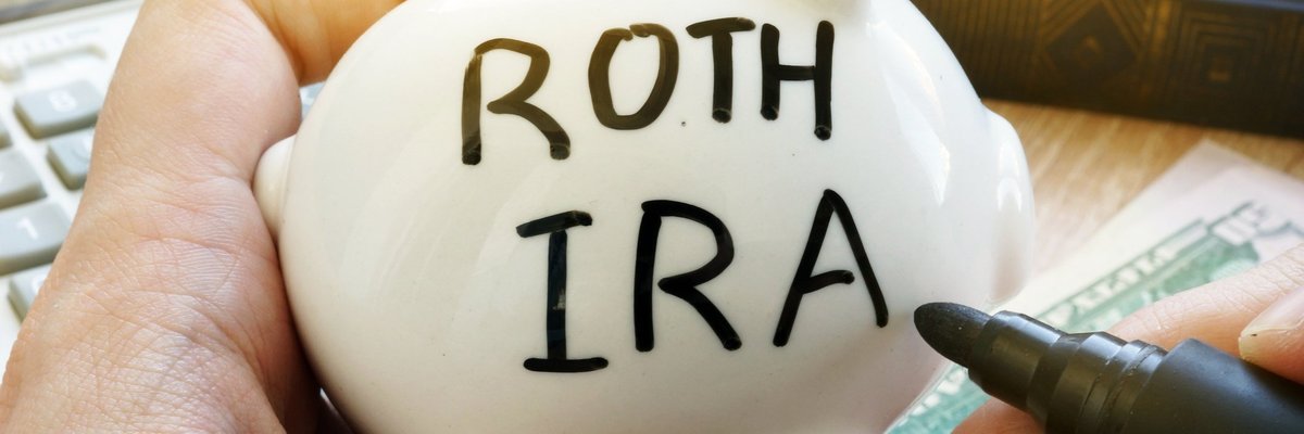 A piggy bank with the words ROTH IRA written on the side.