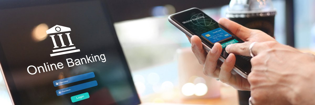 Person using laptop and phone to look at online banking.