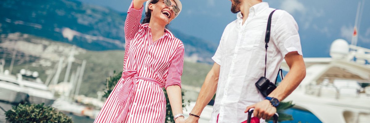 Couple in their 30s smiling while traveling.