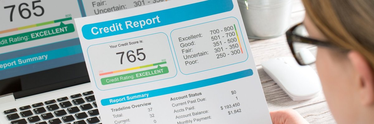 Woman looking at a credit report showing a score of 765