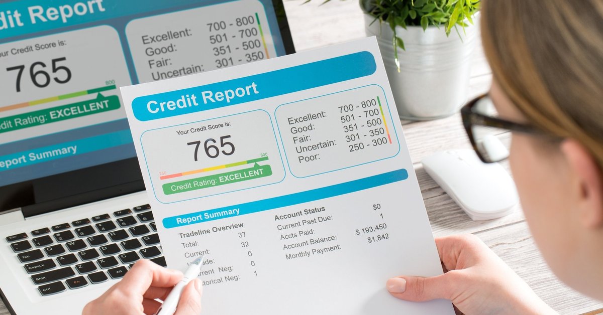 Woman looking at a credit report showing a score of 765
