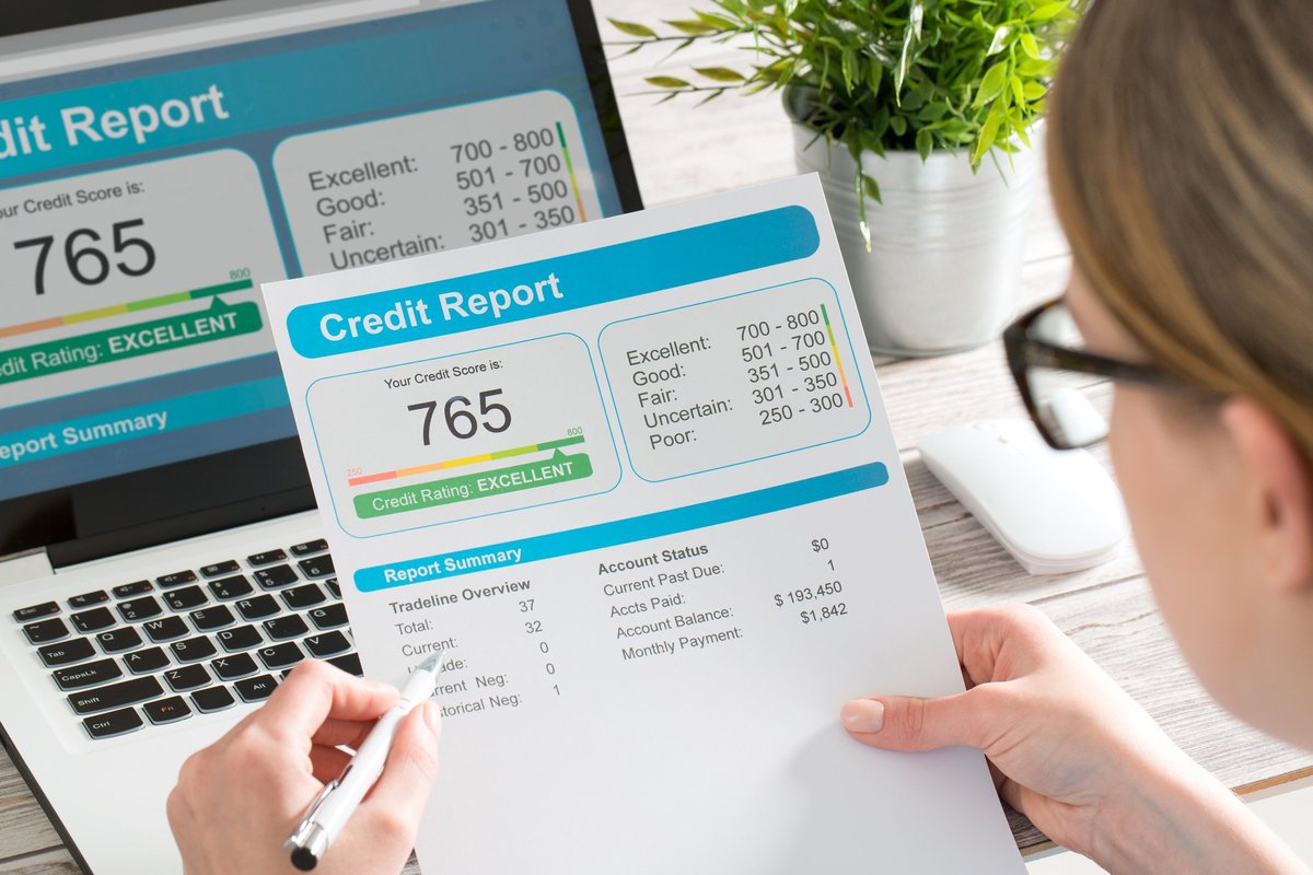 Woman looking at a credit report showing a score of 765