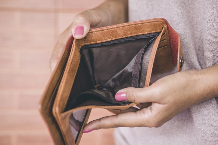 GettyImages-woman_holding_an_empty_wallet_cUzp0nq.jpeg