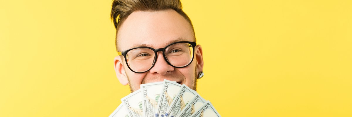 Happy man holding cash.