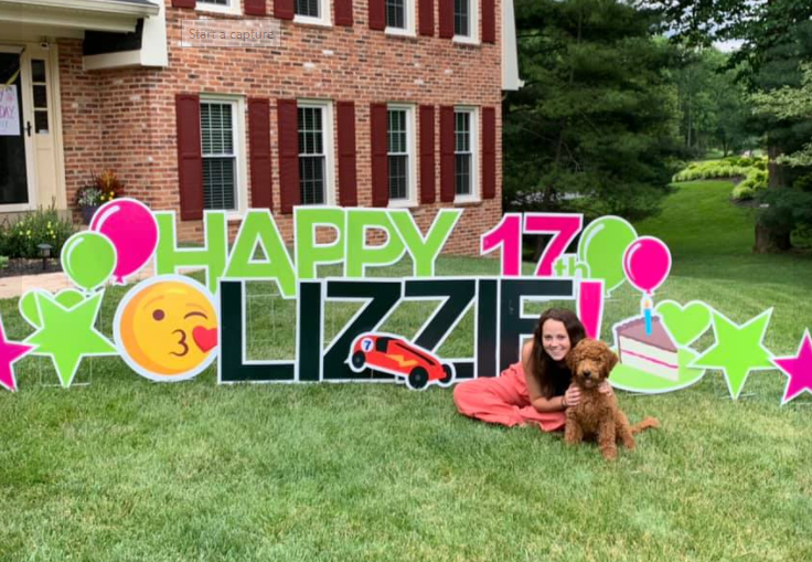 Lizzie Sleight and Green Grass Greetings yard sign celebrating her birthday.