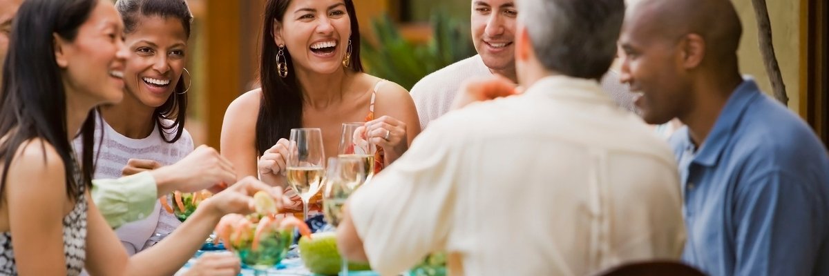 Group of friends dining on restaurant patio.