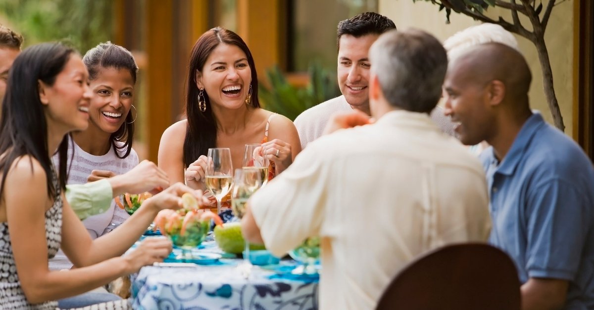 Group of friends dining on restaurant patio.