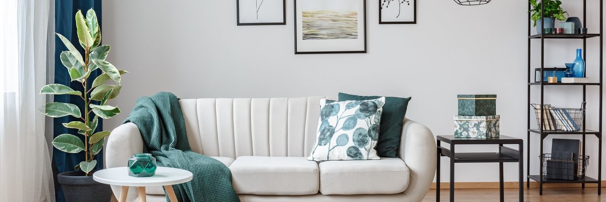 A stylishly decorated living room with green, black, and white accents.