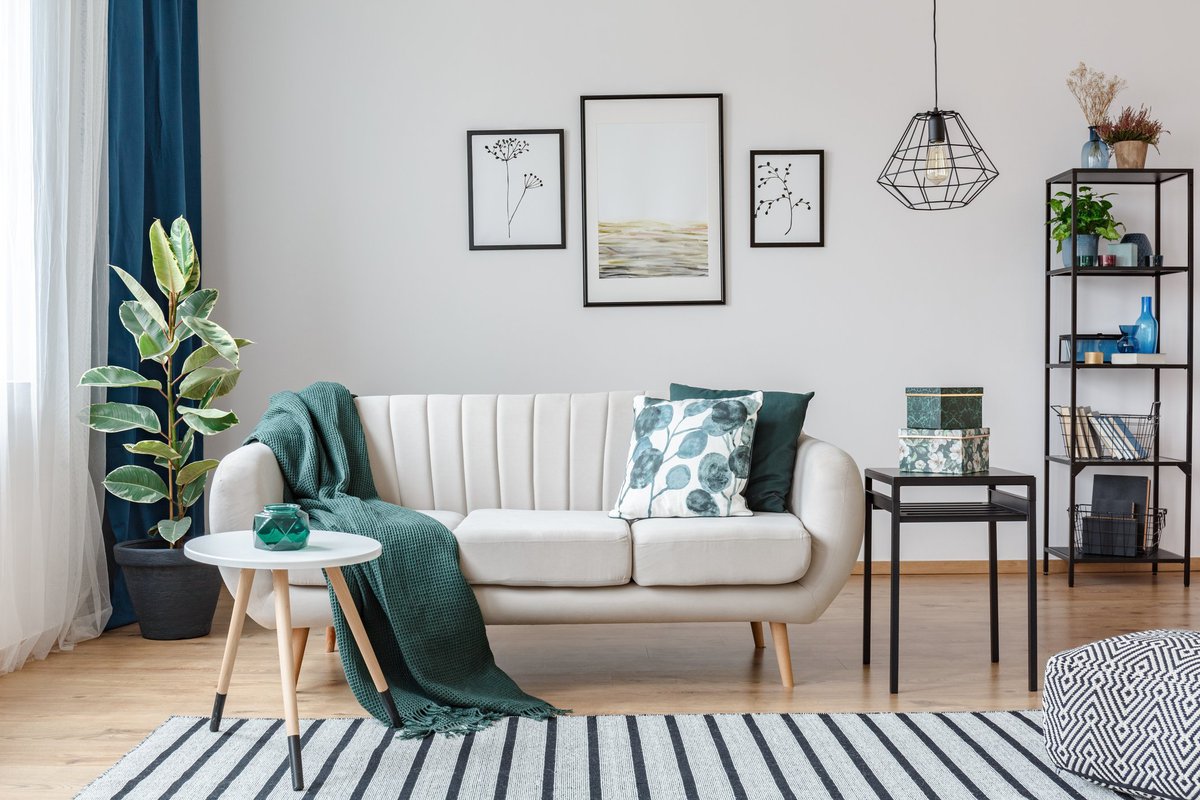 A stylishly decorated living room with green, black, and white accents.