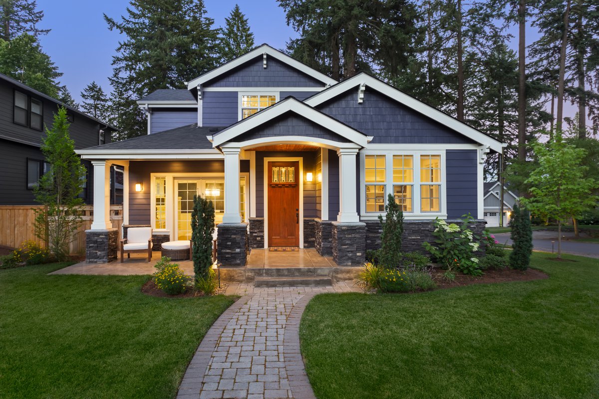 The exterior of a new home at twilight.