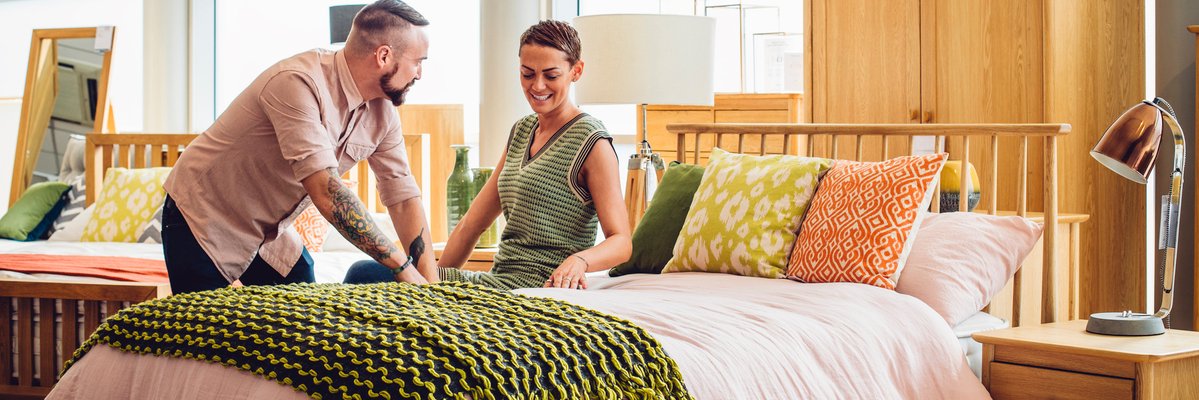 Couple browsing beds at home furnishings store.