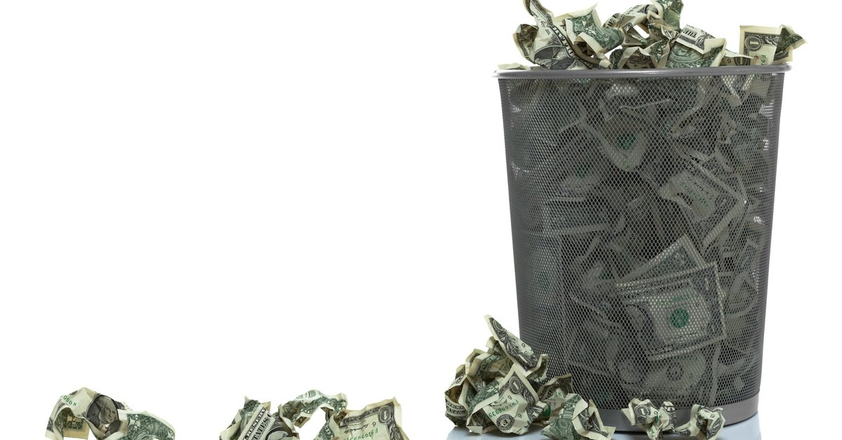 Trash can full of dollar bills.