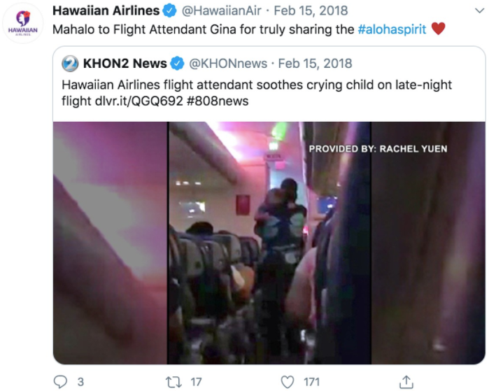 A retweet from Hawaiian Airlines shows a woman carrying a baby in an airplane's passenger aisle.