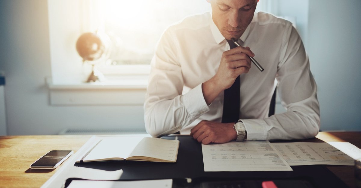 Man looks over report on his desk