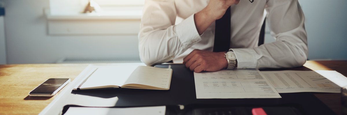 Man sitting at a desk reading documents
