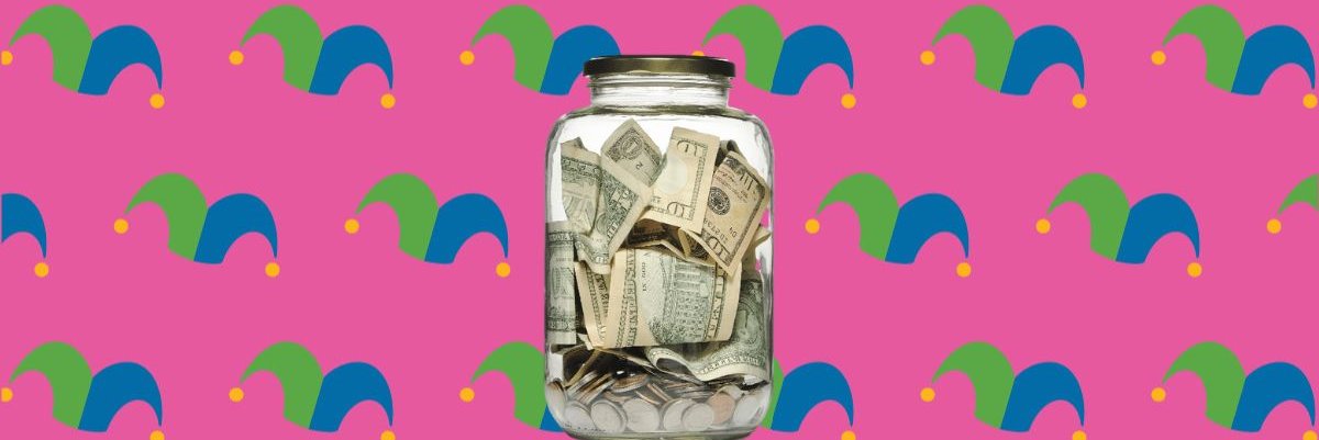 A glass jar full of bills and coins