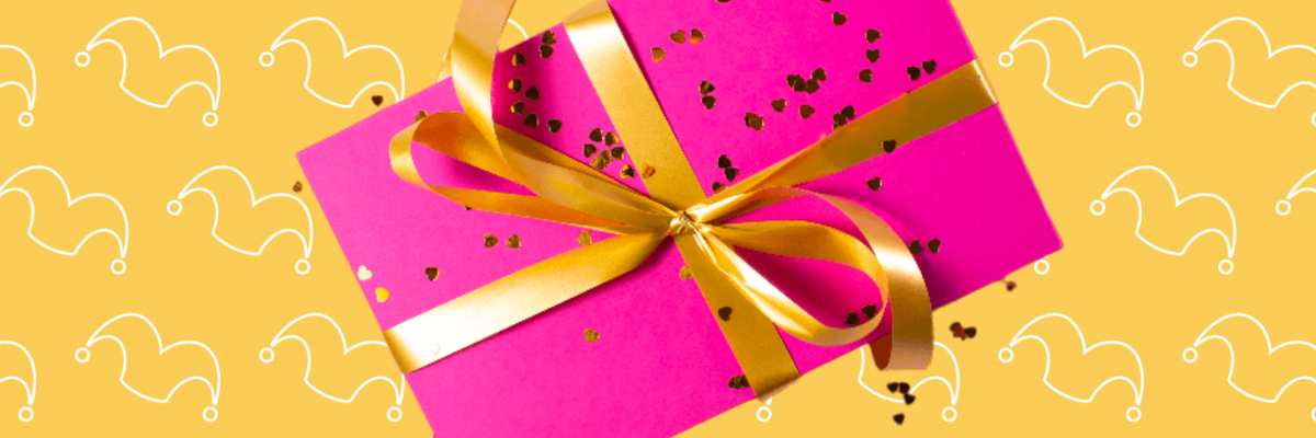 A box wrapped in pink with a gold bow