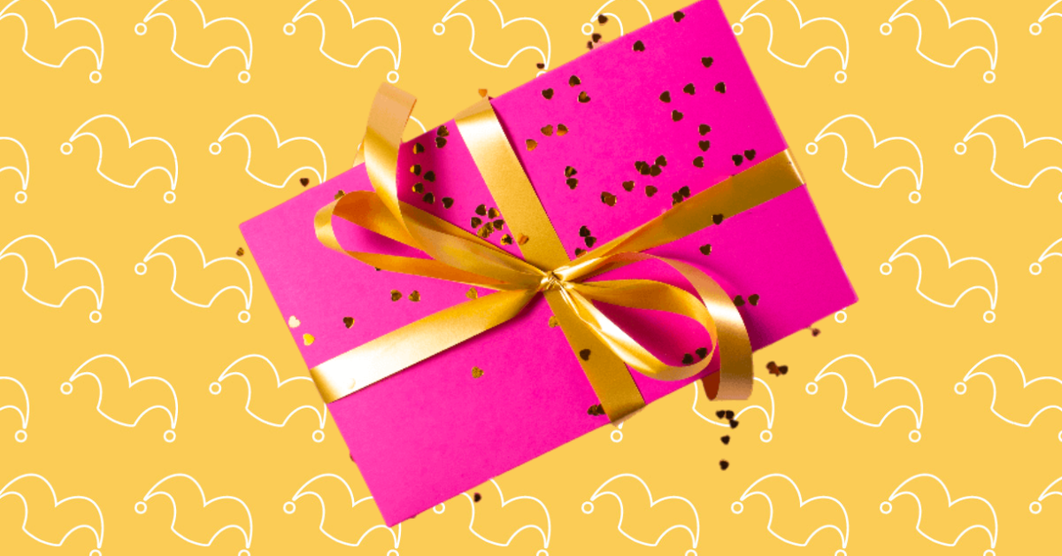 A box wrapped in pink with a gold bow