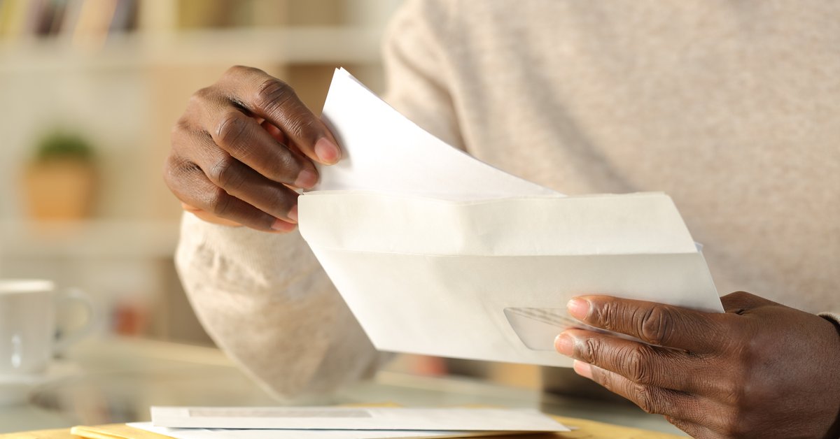 Man Opening Envelope